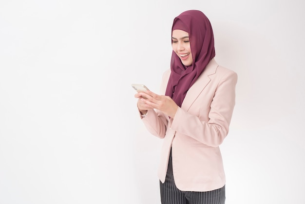 Beautiful business woman with hijab portrait on white wall