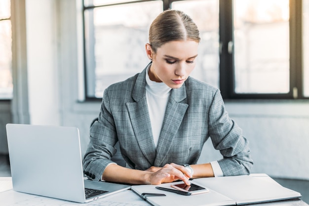 beautiful businesswoman using smartphone in office