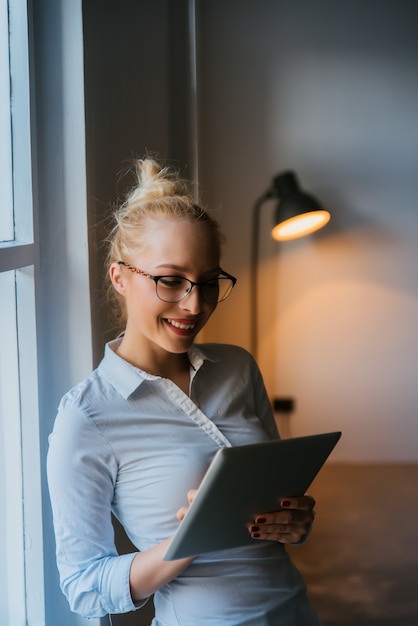 Beautiful businesswoman using tablet in office