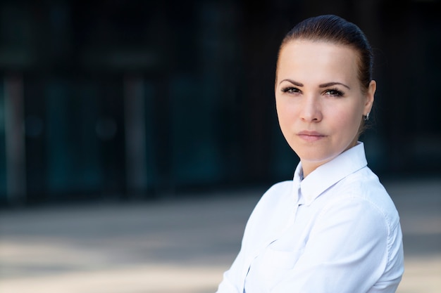 Beautiful businesswoman in white shirt smiling