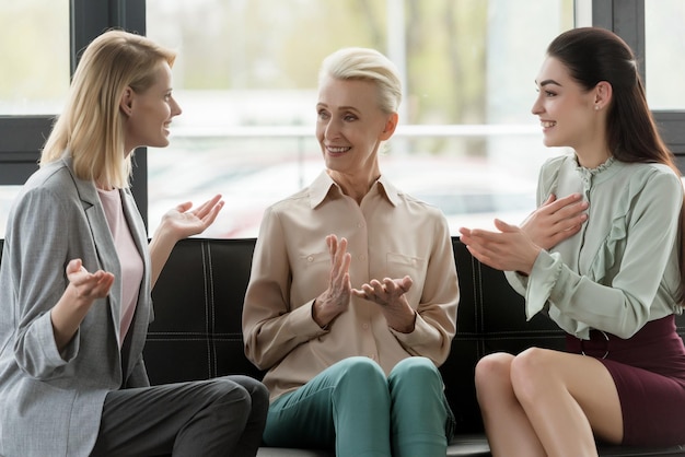 beautiful businesswomen gesturing while talking in office