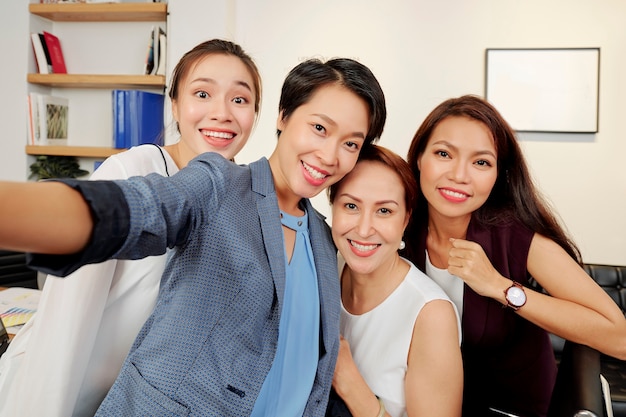 Beautiful businesswomen taking selfie