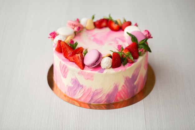 Beautiful cake with strawberries and macaroons