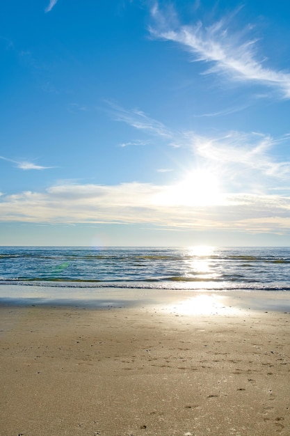 Photo beautiful calm and quiet view of the beach ocean and sea against a cloudy blue sky copy space background on a sunny day peaceful scenic and tranquil landscape to enjoy a relaxing coastal getaway