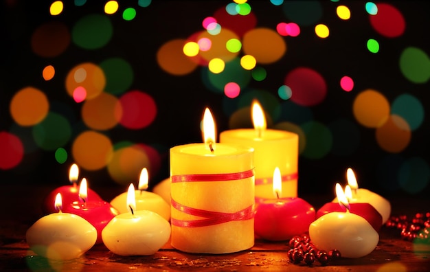 Beautiful candles on wooden table on bright background