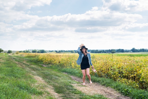 Beautiful carefree woman posing in rural fields  in summer. lifestyle