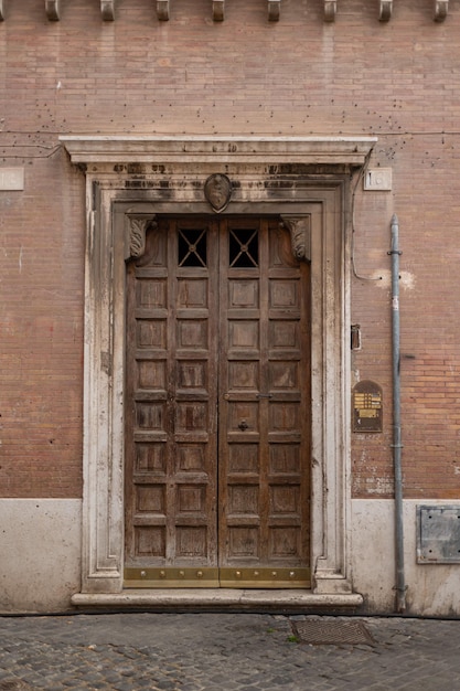 Beautiful carved wooden antique vintage doors on the street in trastevere area