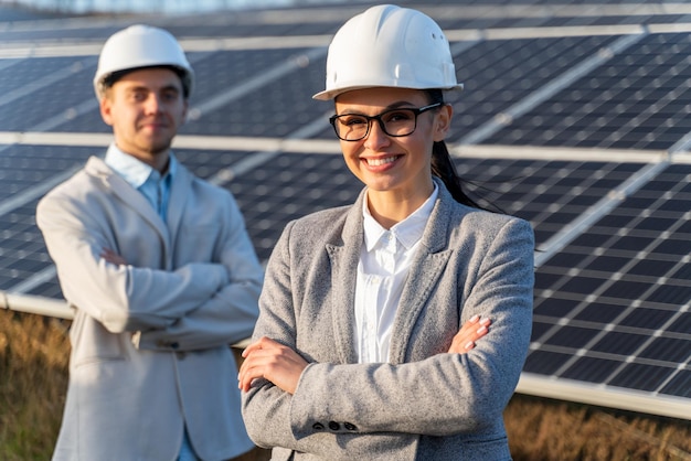 Beautiful Caucasian female standing in front of the solar panel