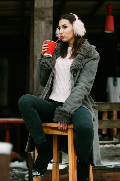 A beautiful caucasian girl drinking hot coffee