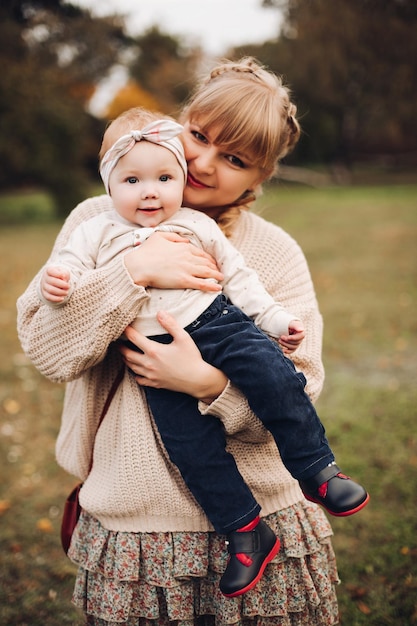 Beautiful caucasian mother with braid embracing her daughter