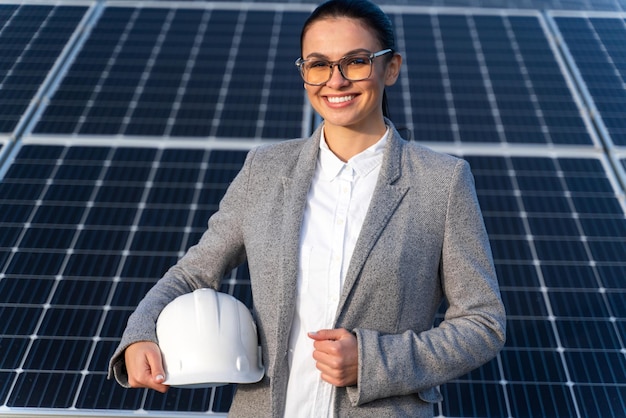 Beautiful Caucasian woman engineer in glasses at the energy farm in countryside