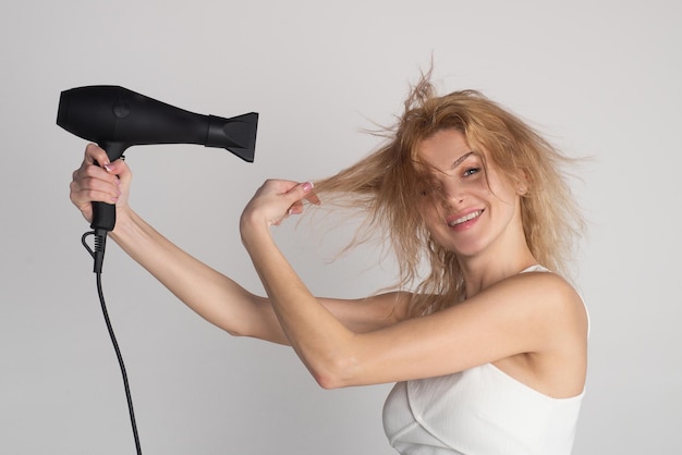 Beautiful caucasian woman posing with wet hair women hair treatment girl with blonde hair using hair