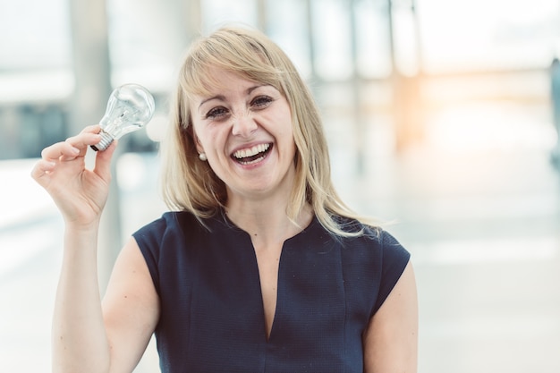 beautiful caucasian woman smile and hand hold light bulb 