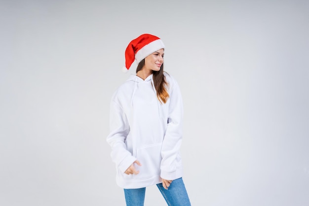 Beautiful caucasian young woman wearing red santa claus hat and white