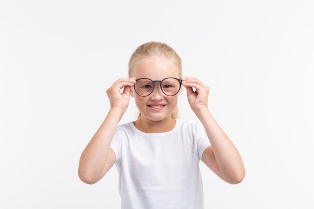 Beautiful child girl wearing glasses isolated on white.