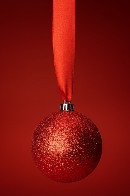 Beautiful christmas bauble hanging on red satin ribbon