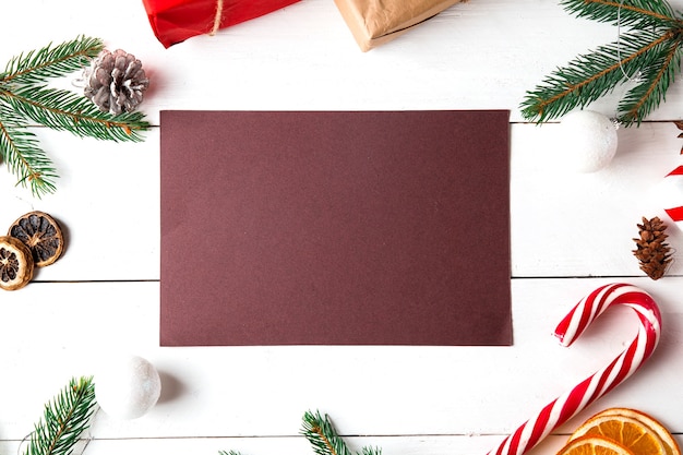 Beautiful Christmas composition on wooden white background. Empty card with Christmas present boxes