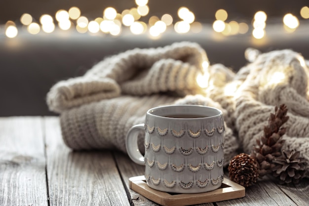 Beautiful christmas cup and candles on blurred background with bokeh