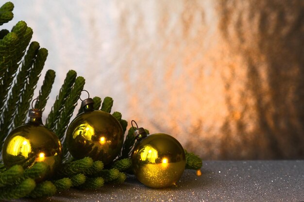 Beautiful Christmas decoration with pine branches golden background and spheres