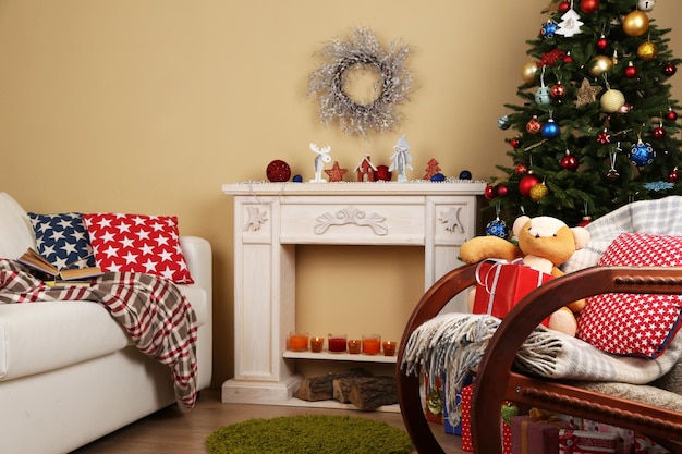 Beautiful Christmas interior with decorative fireplace and fir tree