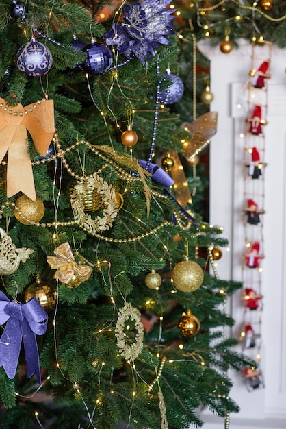 Beautiful Christmas tree with garlands balls and toys Preparing your home for the new year