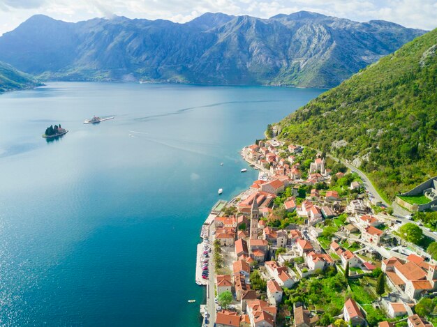 Beautiful city with red roofs in the mountains near the sea