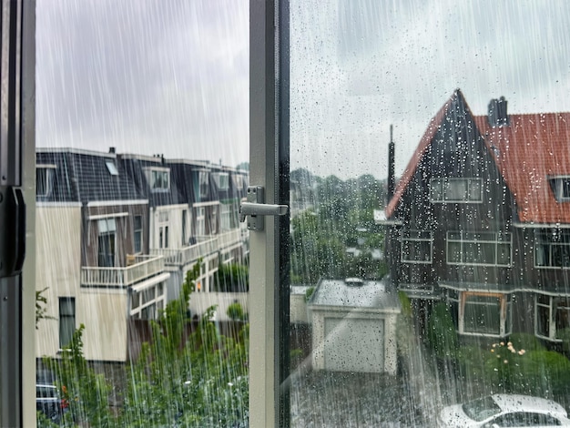 Beautiful cityscape with buildings on rainy day view through open window