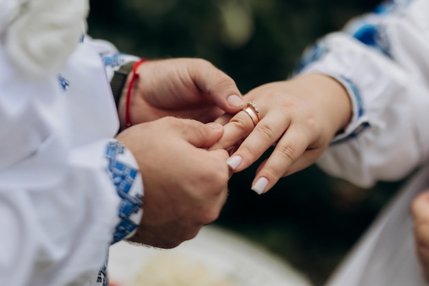 Photo beautiful closeup of a bride and groom exchanging wedding rings during a romantic ceremony