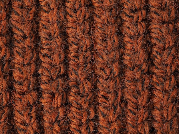 A beautiful closeup of a hand knitted warm and soft wool pattern Texture of a brown sweater socks or scarf orange knitted material background