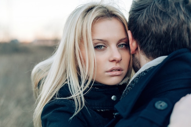 Beautiful closeup portrait with blonde woman and handsome man posing in winter