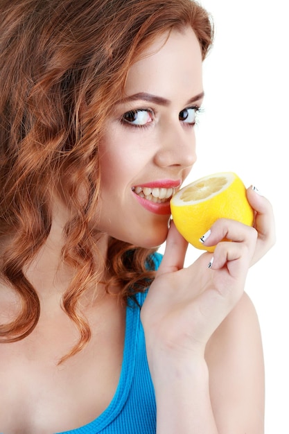 Beautiful closeup young woman with lemons. Healthy food concept