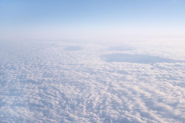 Beautiful cloudy blue sky from airplane window view from abovebeautiful light natural backgroundcopy