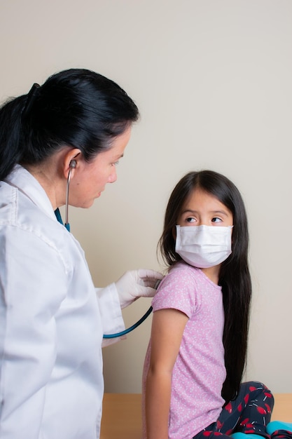 Beautiful Colombian girl is examined by her pediatrician in the consulting room