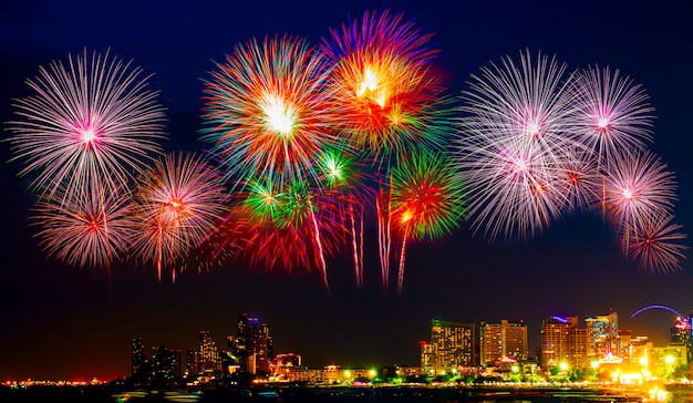 Beautiful colorful fireworks display on the sea beach, Amazing holiday fireworks party or any celebration event in the dark sky.