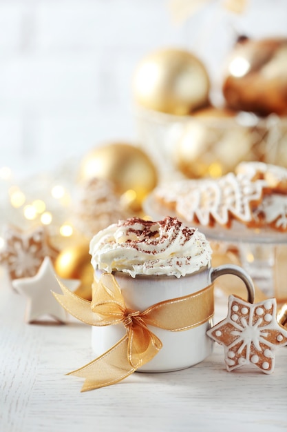 Beautiful composition with cup of cappuccino and Christmas cookies