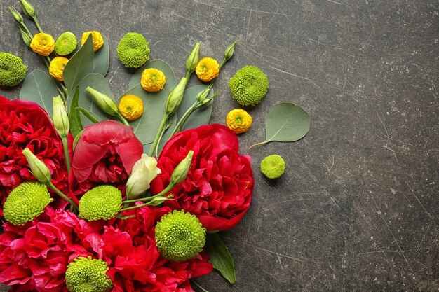 Beautiful composition with flowers and leaves on gray background