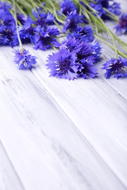 Beautiful cornflowers on wooden background