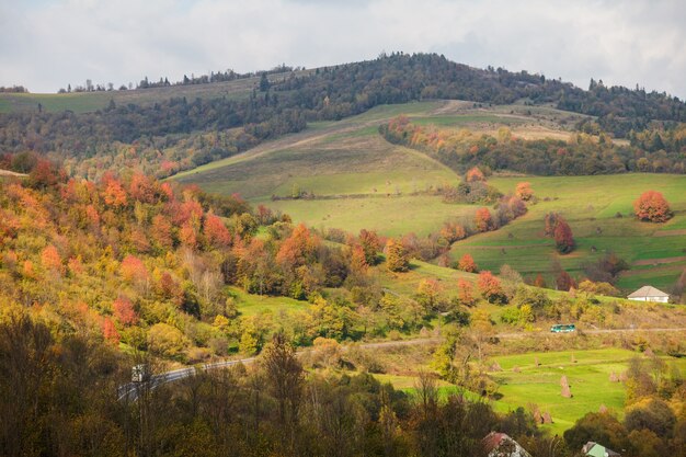 Beautiful country autumnal landscape in mountains. Road throw the Carpathian mountains