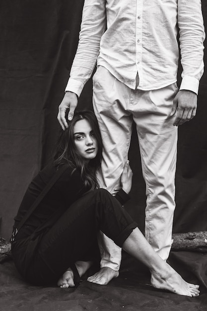 A beautiful couple on a black background is full of emotions