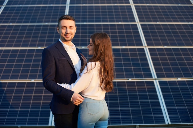 Beautiful couple by a solar panel