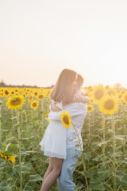 Beautiful couple having fun in sunflowers fields