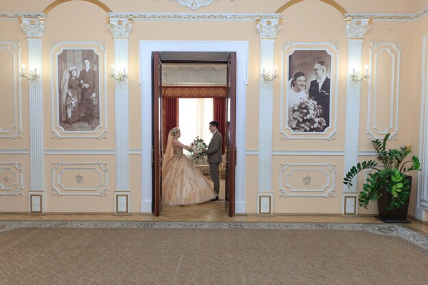 The Beautiful couple in love. Wedding ceremony. REGISTRY OFFICE. Newlyweds in a beautiful room.