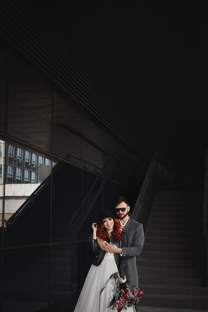 Beautiful couple of lovers hugging outdoors during wedding photoshoot slim young woman with red hair...