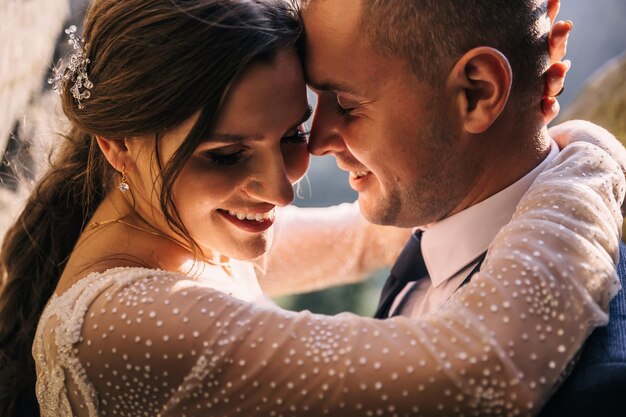 Beautiful couple of newlyweds hugging at the wedding ceremony Closeup of a happy man and woman