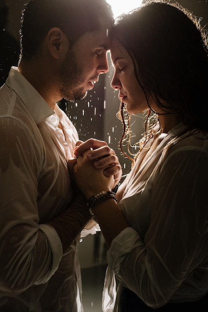 Beautiful couple under the rain at night time, romantic view, walking and kissing couple.