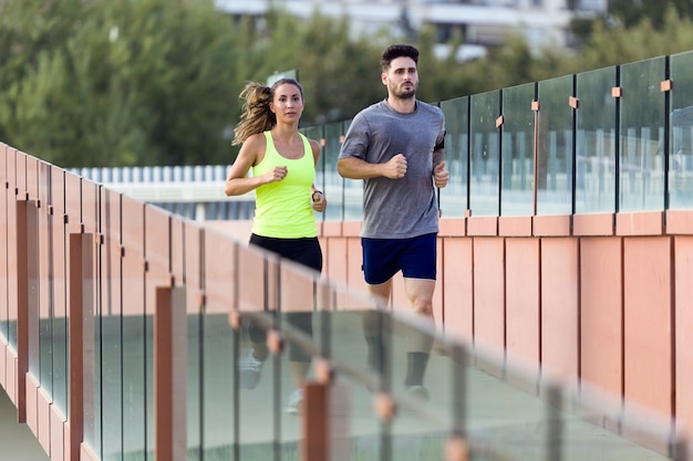 Beautiful couple running in the street.