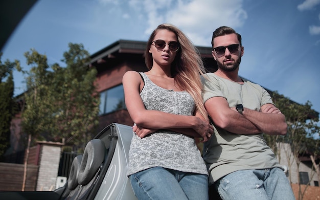 Beautiful couple standing near their comfortable car