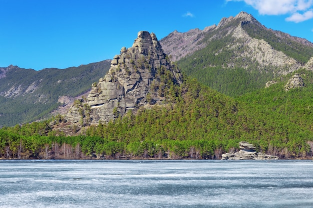 Beautiful crag Okzetpes and "puzzle-stone" pyramid Zhumbaktas in Burabay National Nature Park, Kazakhstan. Picturesque mountain landscape.