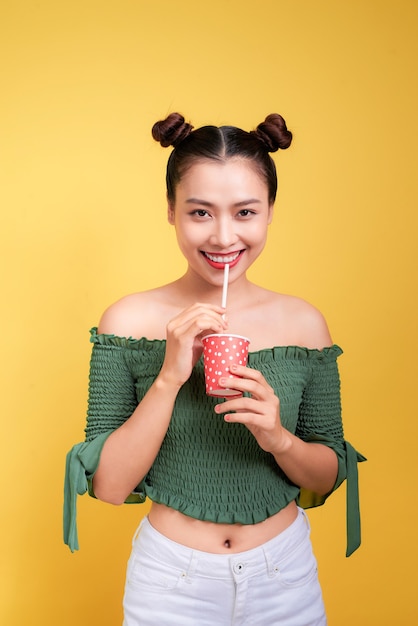 Beautiful crazy smiling asian woman girl with red lips drinking cola with straw