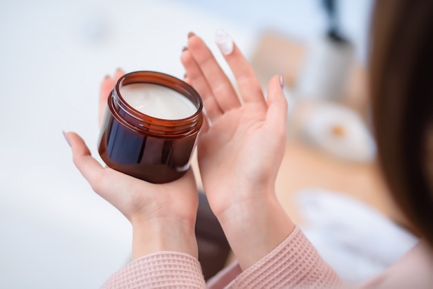 A beautiful cream bottle in hand